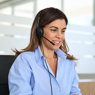 Call center representative uses headset to speak with a customer