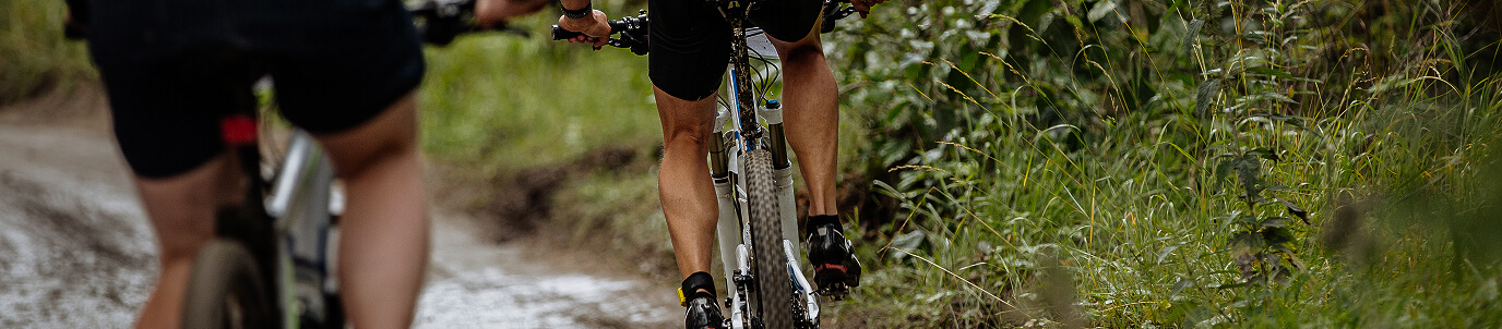 People peddling bikes